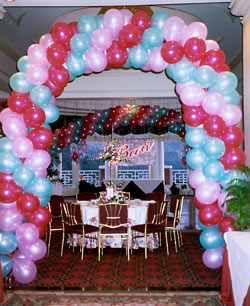 Balloon Arch and Name Sign behind Disc Jockeys